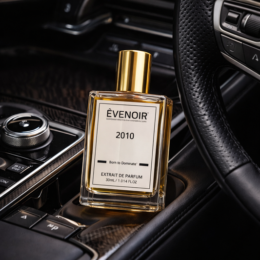 Luxury perfume bottle with gold cap labeled 2010 placed in a car interior
