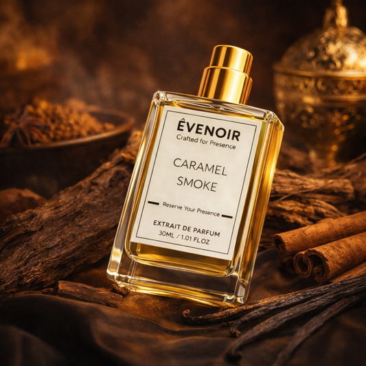 Caramel Smoke perfume bottle with gold cap, surrounded by wood, spices, and cinnamon sticks