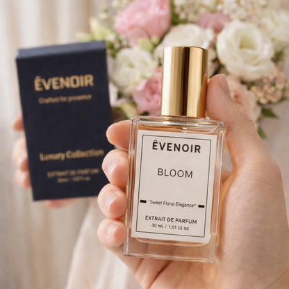 Hand holding a Bloom perfume bottle with gold cap, floral background, and product box