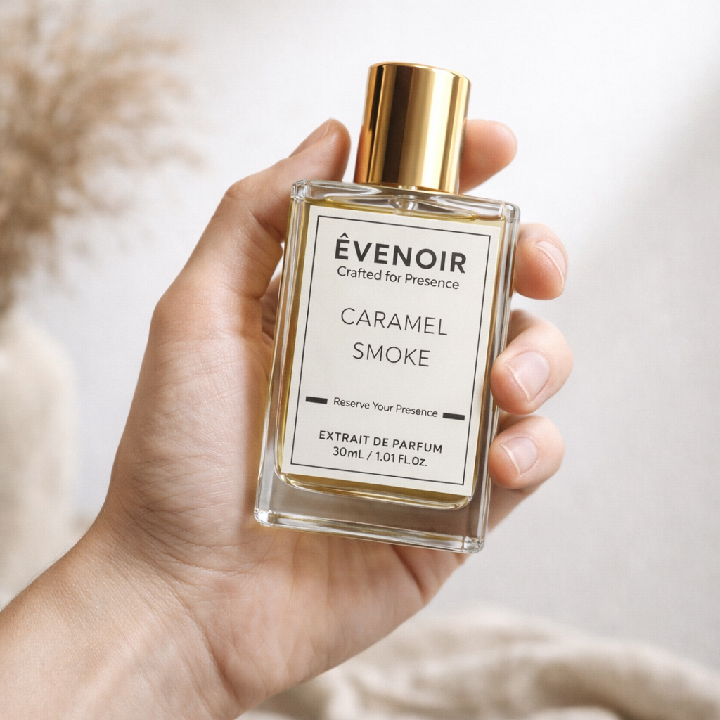 Hand holding a rectangular Caramel Smoke perfume bottle with gold cap, minimal label design