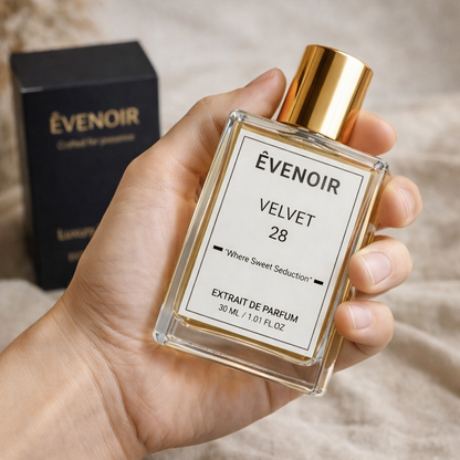 Hand holding a 30ml bottle of VELVET 28 extrait de parfum with a gold cap